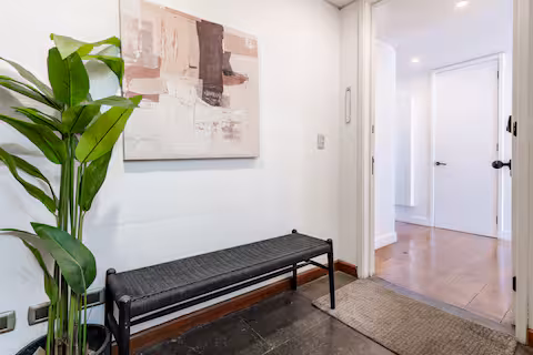 Pasillo interior con banca y arte